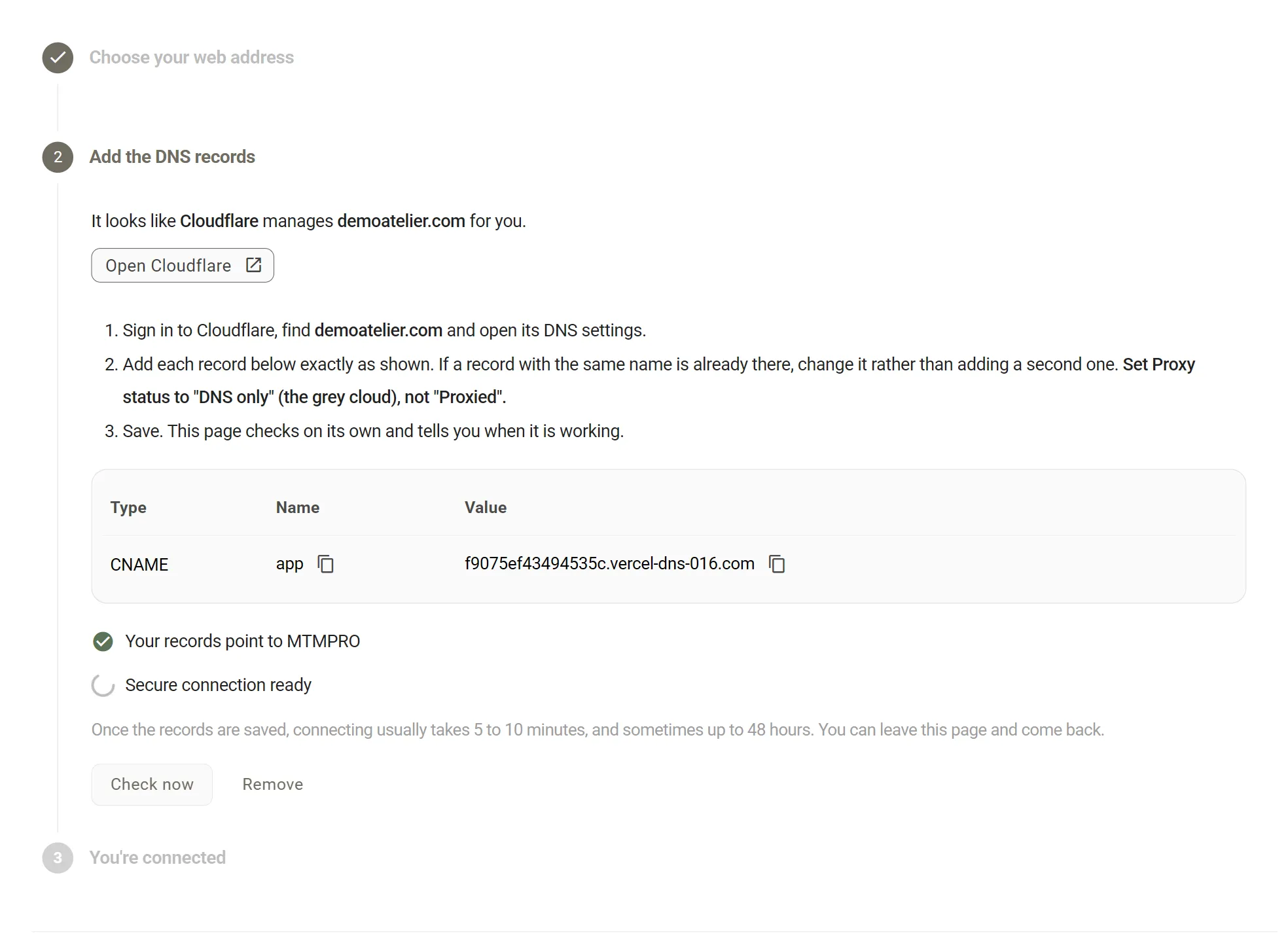 The Add the DNS records step. It reads It looks like Cloudflare manages demoatelier.com for you, with an Open Cloudflare button, three numbered instructions, a table with one CNAME record named app, and a checklist underneath with Your records point to MTMPRO ticked and Secure connection ready still waiting.